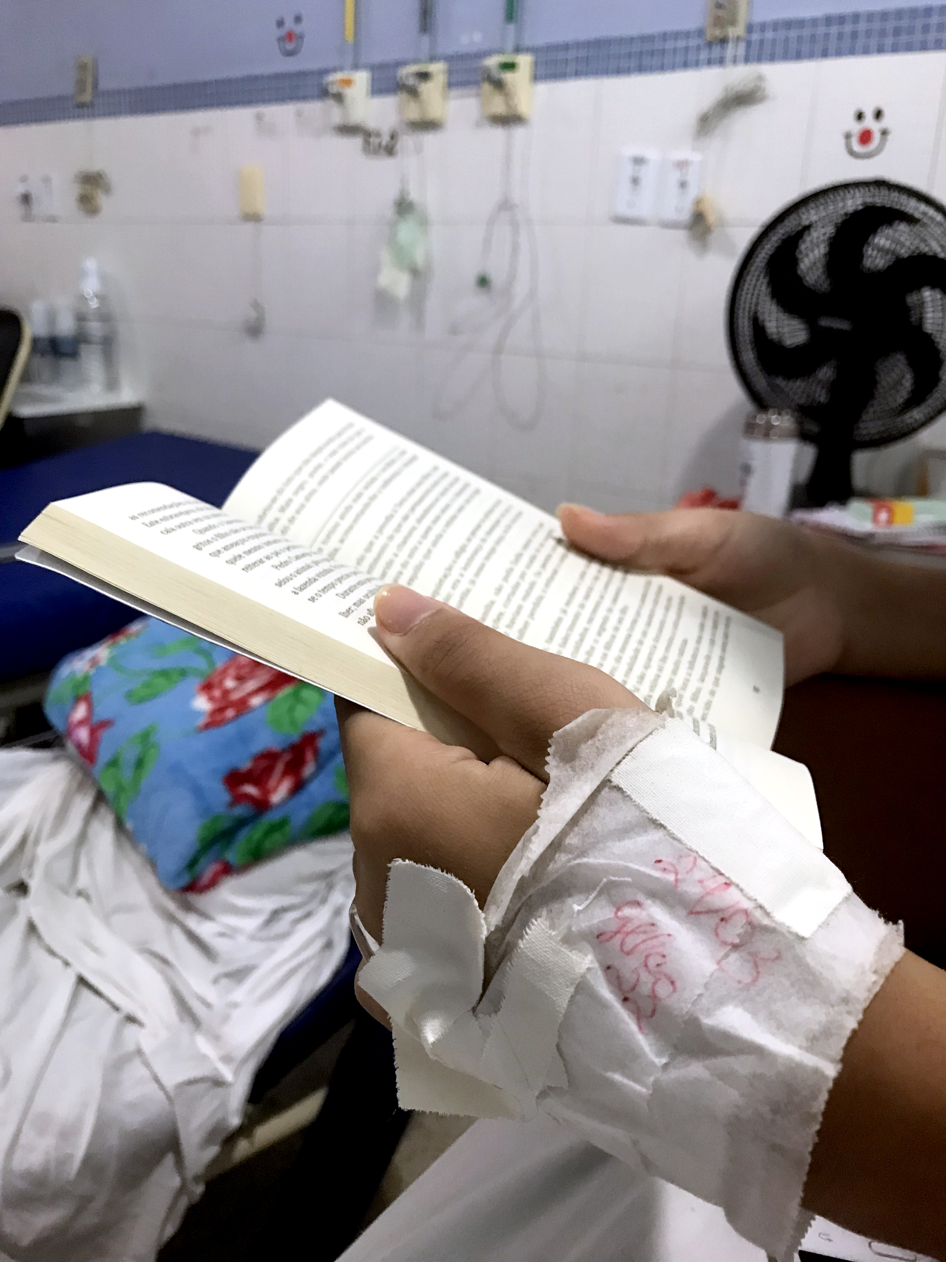 #PraCegoVer - Distante da escola, adolescente internada lê para passar o tempo